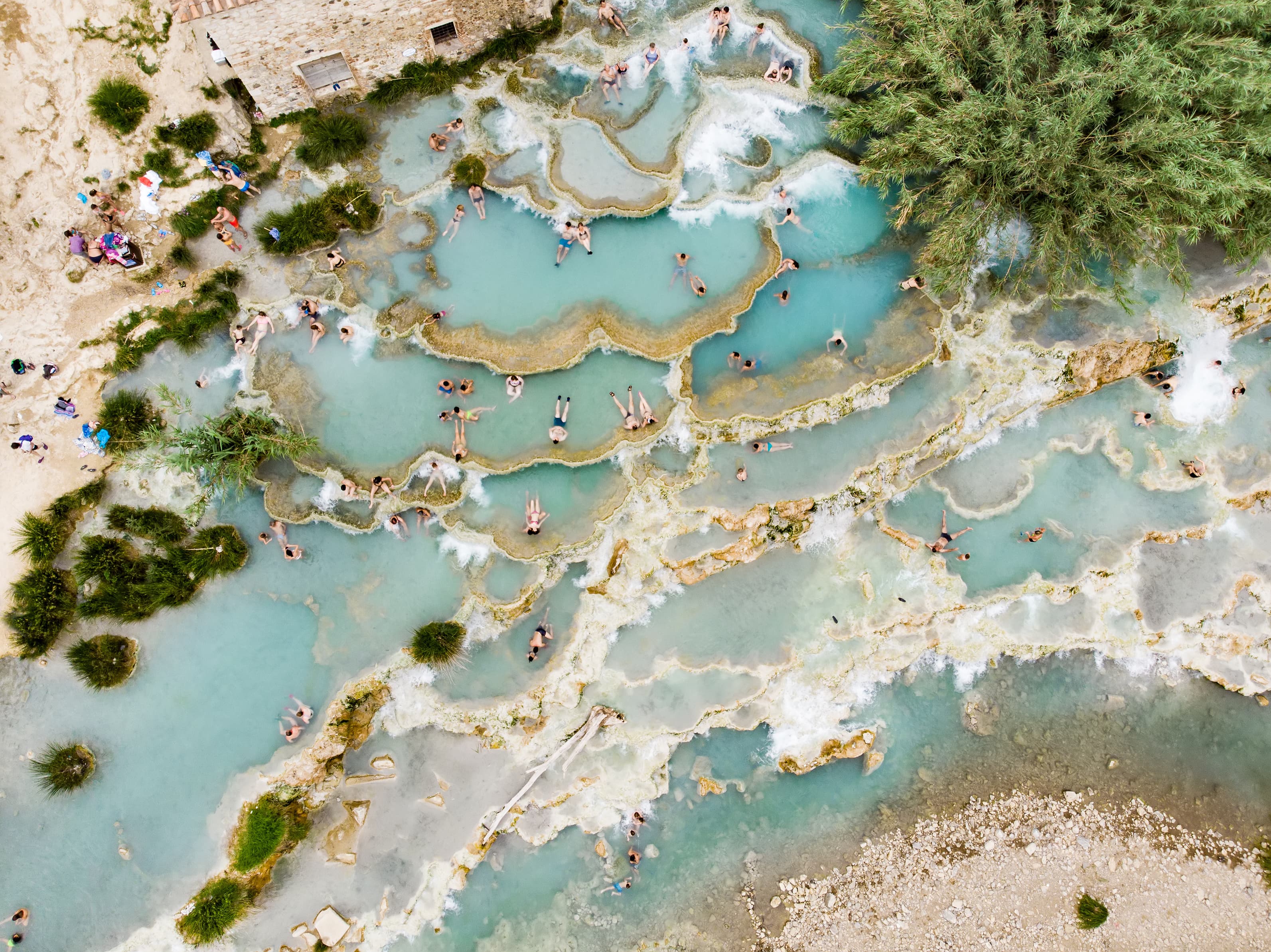 A natural thermal resort with people relaxing in the spring water