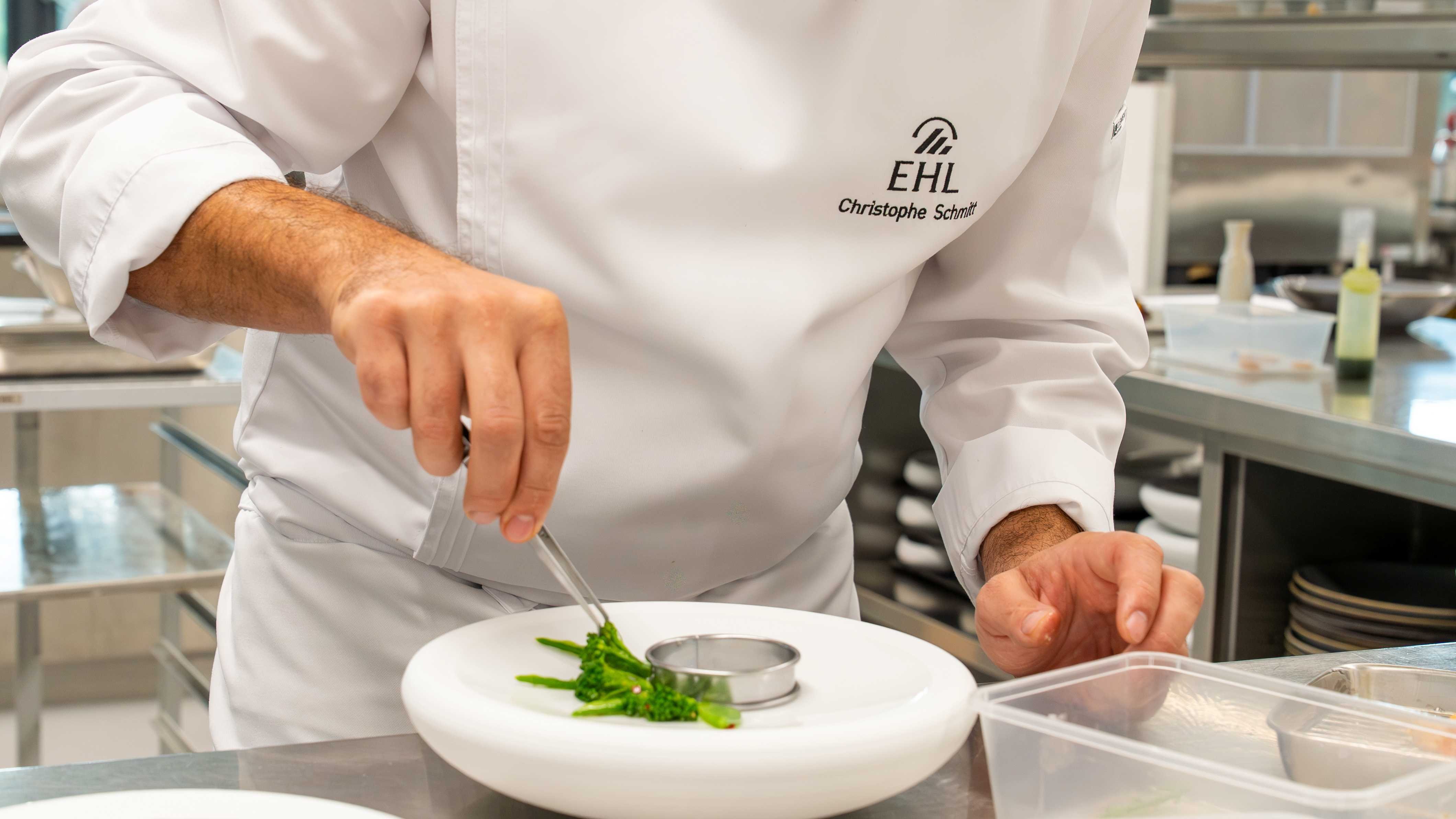 Chef Christophe Schmitt using precision plating tweezers at EHL Berceau des Sens
