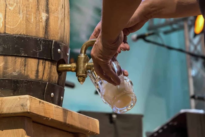 Fresh Craft Beer Poured from a Wooden Barrel