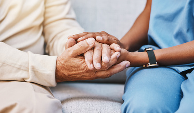 Nurse holding patients hands