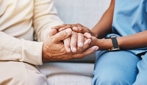 Nurse holding patients hands