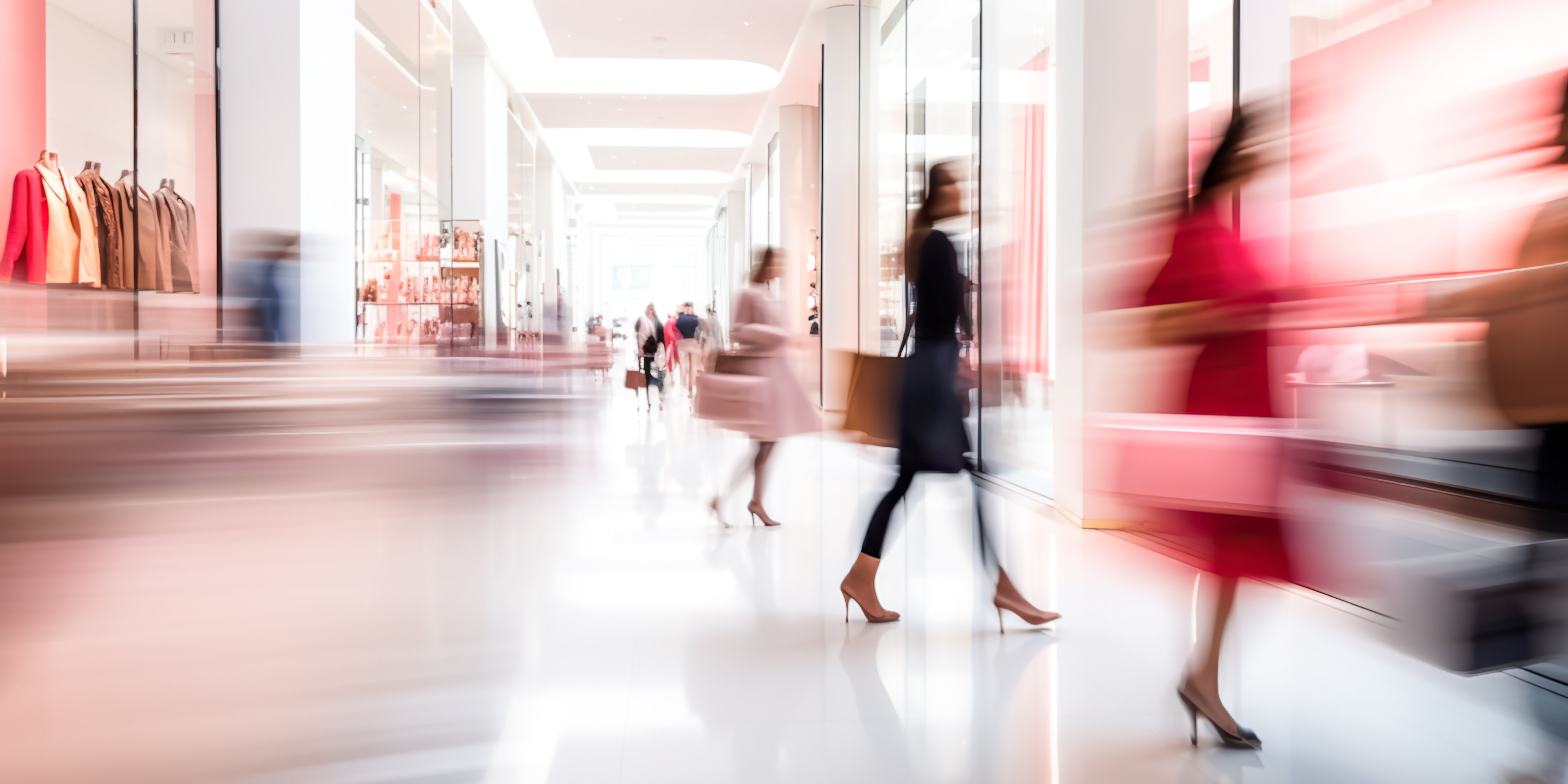Blurred view of shopping mall with girls doing shopping