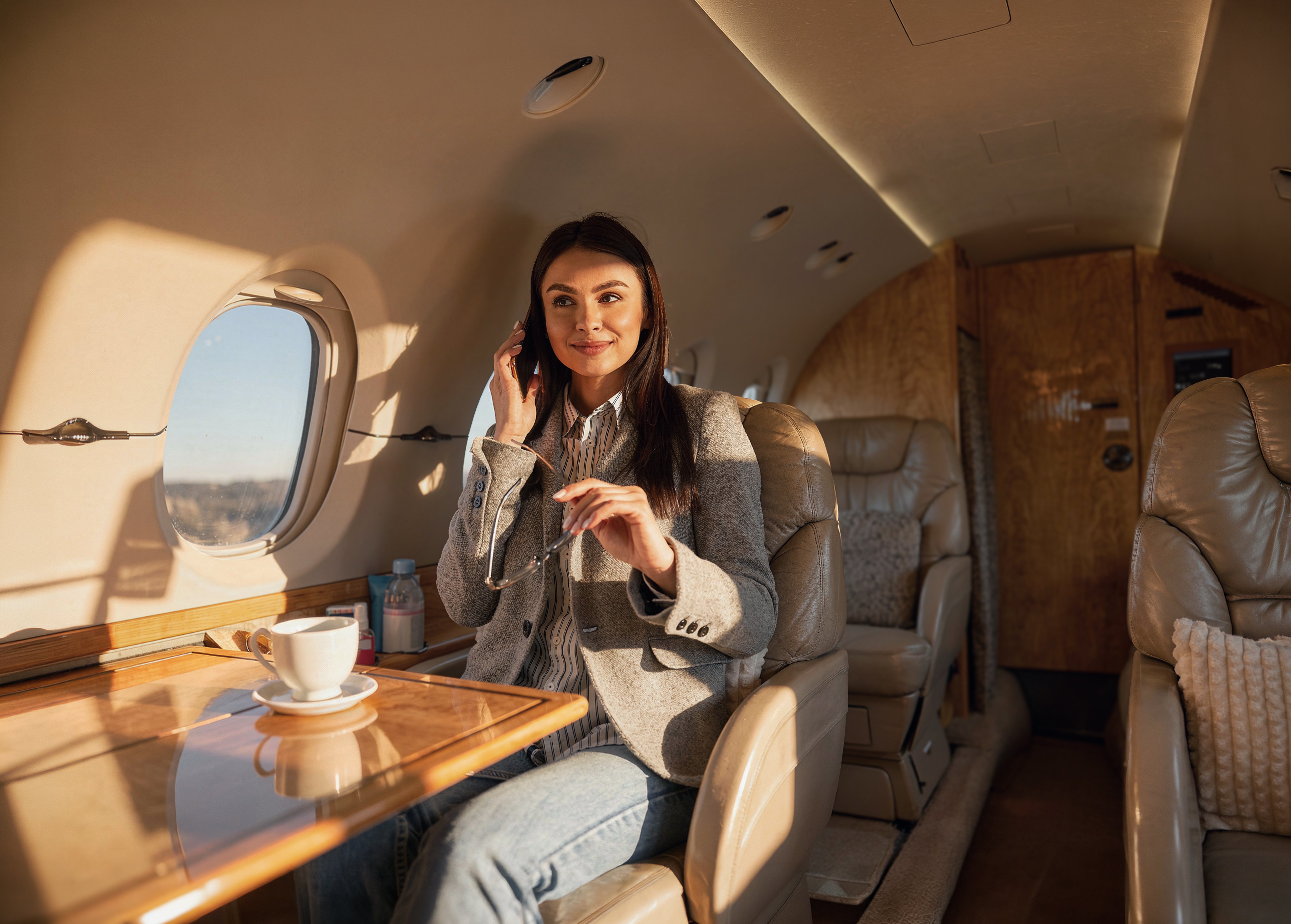 Woman experiencing a serene vibe inside a luxury plane during golden hour