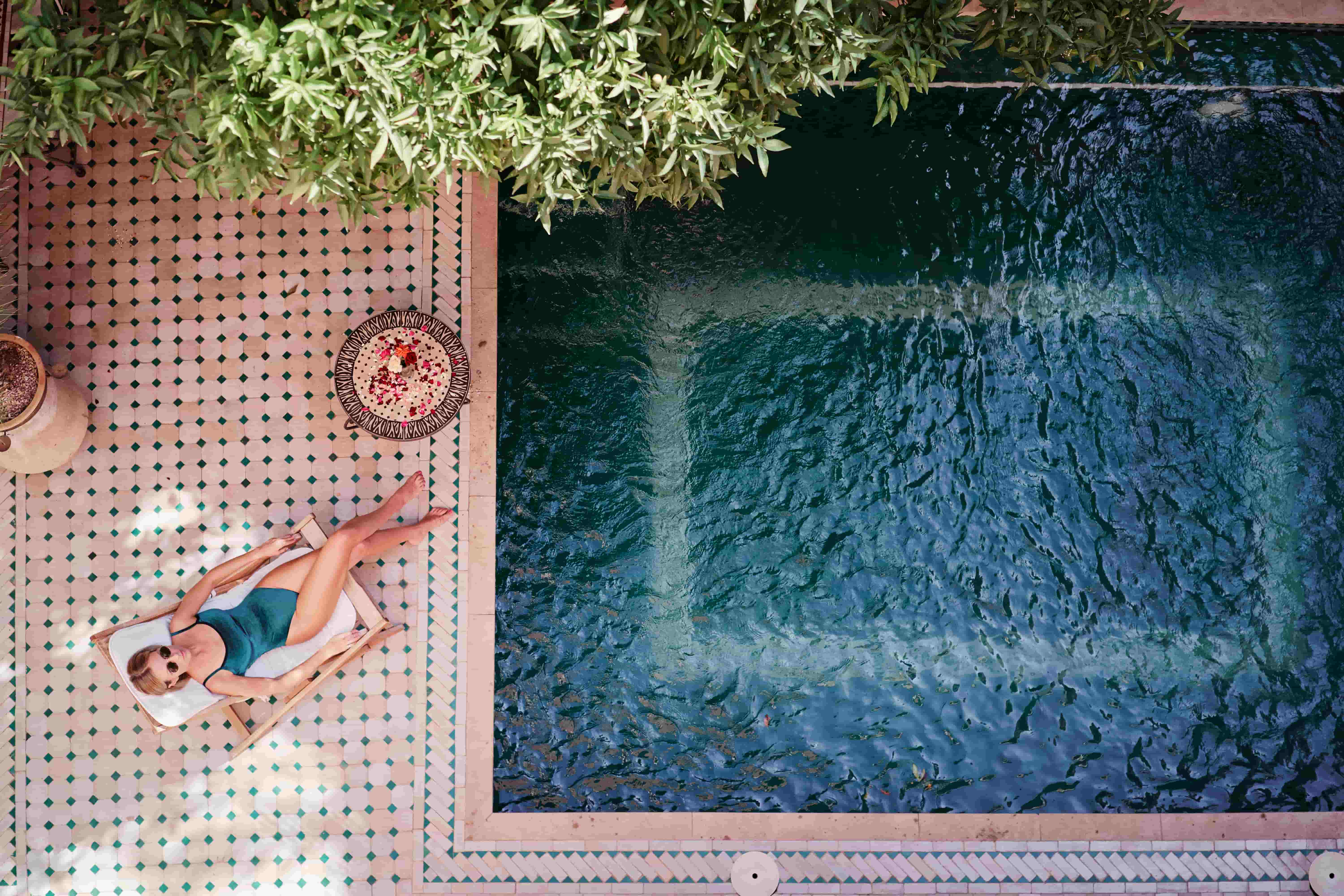 women relaxing by luxury hotel pool