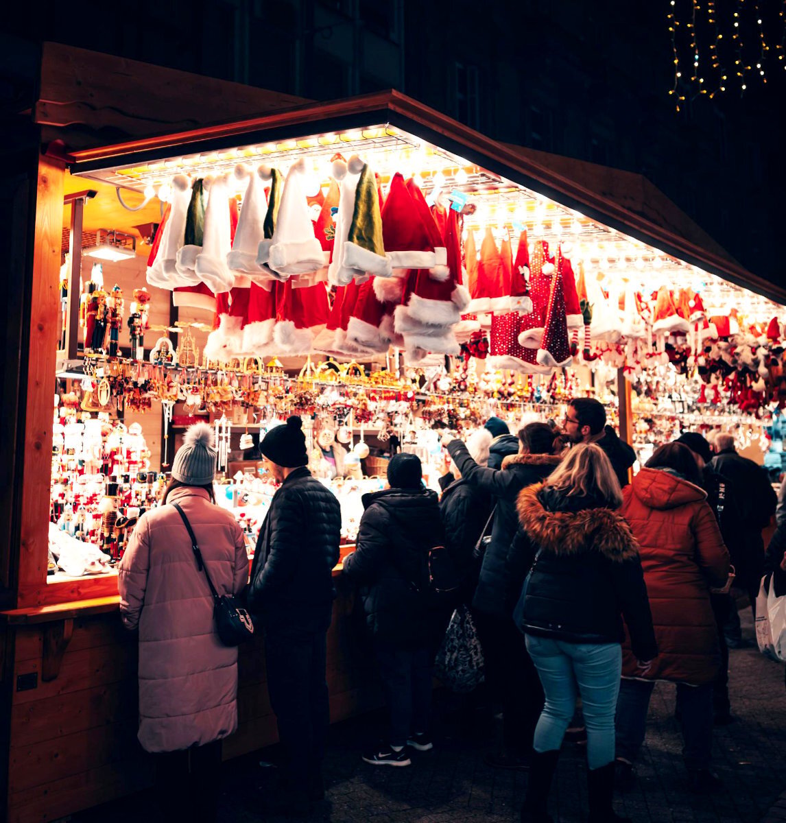 People huddled around a stall at a Christmas market