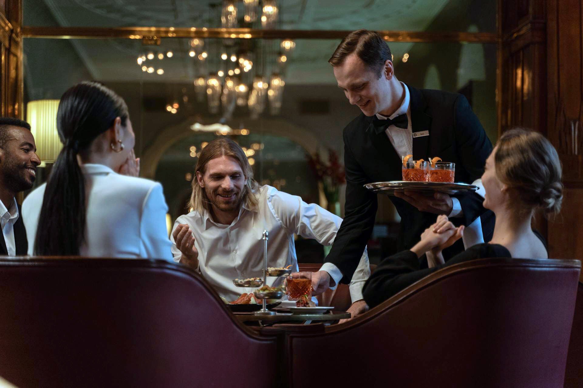 Happy guests being served drinks
